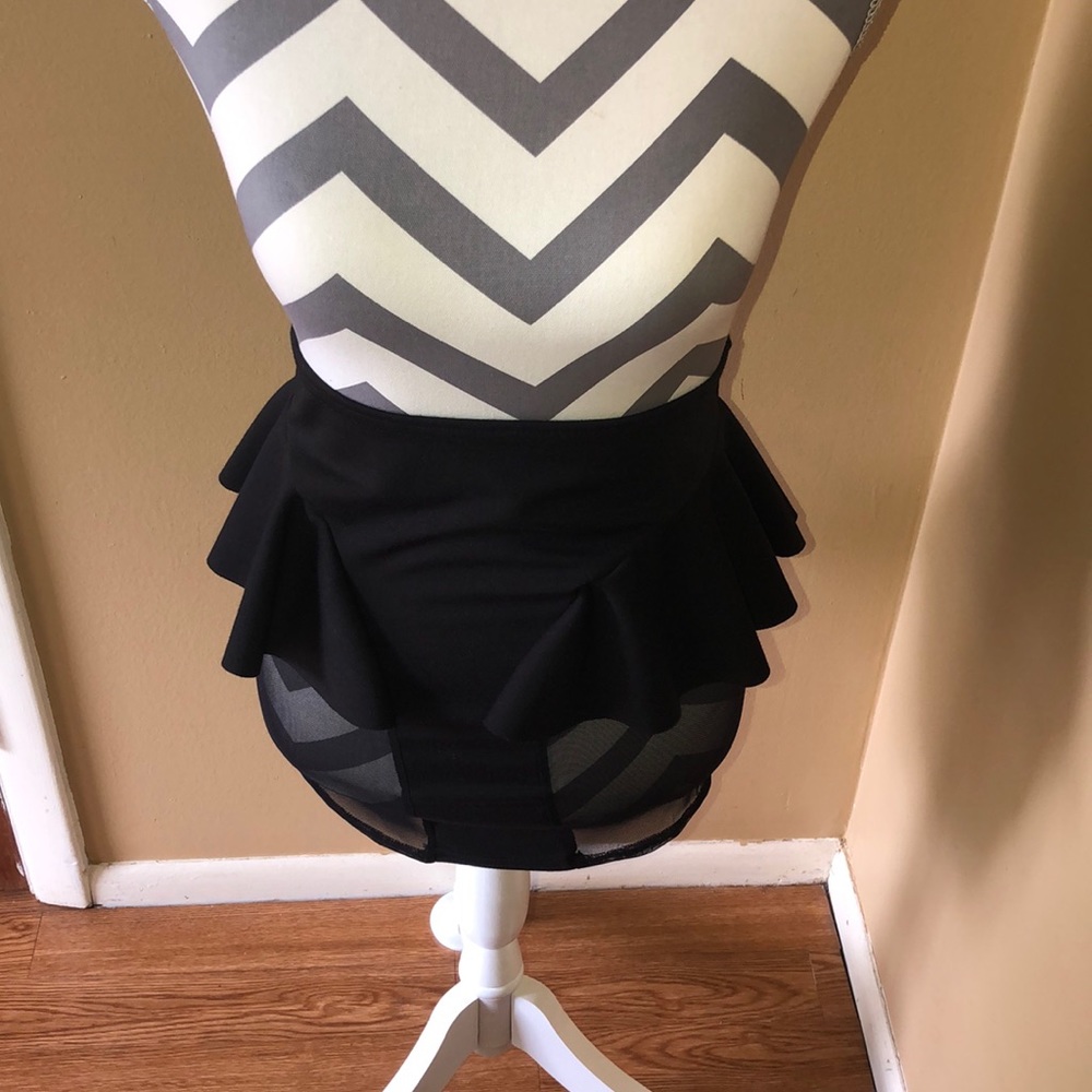 A black mini skirt with sheer sides.